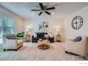 Open living room featuring neutral tones, soft carpet, and stylish furnishings at 907 Stein St, Lafayette, CO 80026
