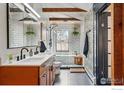 Bright and modern bathroom with double vanity, subway tile, and sleek black fixtures at 10978 W 82Nd Pl, Arvada, CO 80005