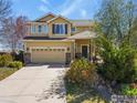 Charming two-story home with a brick-accented garage, front porch, and mature landscaping at 11470 Ebony St, Firestone, CO 80504