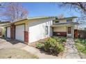 Inviting single-story home featuring brick accents, a well-manicured garden, and covered entryway at 1209 Centaur Cir # B, Lafayette, CO 80026