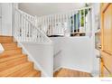 Bright staircase with light wood steps and white railings, leading to the upper level at 1209 Centaur Cir # B, Lafayette, CO 80026