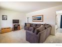 Comfortable living room featuring a plush gray sectional sofa, carpeted floors, and natural light at 1275 Berea Dr, Boulder, CO 80305