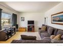 Comfortable living room with neutral carpeting, large windows, and a gray sectional sofa at 1275 Berea Dr, Boulder, CO 80305
