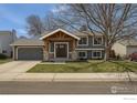 Charming two-story home with a covered porch and well-maintained front yard at 145 S Buchanan Ave, Louisville, CO 80027