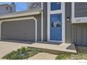 Close-up of home featuring a vibrant blue front door and an attached garage at 145 S Buchanan Ave, Louisville, CO 80027