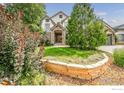 Charming home with well-maintained lawn, stone accents, and mature trees at 1521 Orion Pl, Longmont, CO 80504