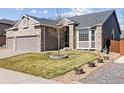 Beautifully landscaped front yard with brick accents and a well-maintained lawn at 1536 Goshawk Dr, Longmont, CO 80504