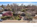 Ranch-style home with mature trees, a well-manicured lawn, and an attached two-car garage at 1746 Shavano St, Longmont, CO 80504