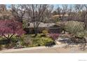 Charming home with a well-maintained front lawn, mature trees, and a two-car attached garage at 1746 Shavano St, Longmont, CO 80504