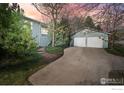 Home exterior view with a long driveway leading to a detached two-car garage at 1780 Redwood Ave, Boulder, CO 80304