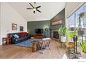 Bright living room features vaulted ceilings, a cozy fireplace, and large windows offering plenty of natural light at 1865 Trevor Cir, Longmont, CO 80501