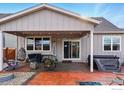 Covered patio with comfortable seating, barbecue grill, hot tub, string lights, and a cozy atmosphere at 226 Ole Bessie Dr, Berthoud, CO 80513