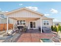 Inviting backyard features a covered patio with seating, fire pit, and a luxurious hot tub at 226 Ole Bessie Dr, Berthoud, CO 80513