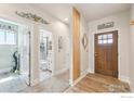 Welcoming entryway featuring a wood door, modern finishes, and convenient access to laundry and bathroom at 226 Ole Bessie Dr, Berthoud, CO 80513