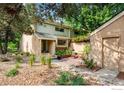 Charming home exterior featuring a cozy patio, mature trees, and rock landscaping creating a serene outdoor space at 2728 Northbrook Pl, Boulder, CO 80304