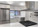 Bright white kitchen featuring stainless steel appliances, gas cooktop, and view of the lake at 2728 Northbrook Pl, Boulder, CO 80304