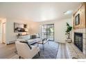 Cozy living room featuring a fireplace, modern decor, and a sliding door to the balcony at 2800 Kalmia Ave # C212, Boulder, CO 80301
