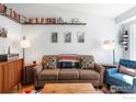 Cozy living room featuring a comfortable sofa, bookshelf, and stylish decor at 3032 W Yarrow Cir, Superior, CO 80027
