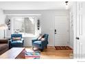 Bright living room with hardwood floors, large window, and comfortable seating area at 3032 W Yarrow Cir, Superior, CO 80027