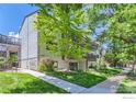 Charming multi-story condo building with well-maintained lawn, mature trees, and a walkway at 3295 34Th St # 62, Boulder, CO 80301