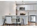 Contemporary kitchen featuring a stainless steel microwave, oven, and dishwasher next to a glass dining table at 3300 Bridger Trl # 110, Boulder, CO 80301