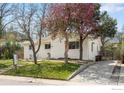 Charming single-story home with a well-kept lawn, driveway, and mature trees adding curb appeal at 345 Colgate St, Boulder, CO 80305