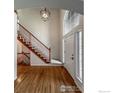 Open foyer featuring hardwood floors, a staircase, and a soaring ceiling at 355 Sprucewood Ct, Lafayette, CO 80026