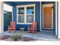 Inviting front porch with two rocking chairs, perfect for relaxing and enjoying the neighborhood scenery at 364 Shawnee Ln, Superior, CO 80027