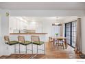 Bright kitchen featuring white cabinets, and a dining area with wood table at 4819 White Rock Cir # C, Boulder, CO 80301