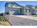 Charming two-story home with a well-maintained front yard and covered porch, perfect for relaxing outdoors at 5805 Red Barn Ave, Mead, CO 80542