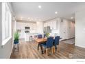 Bright eat-in kitchen with stainless steel appliances, white cabinets and an island providing a modern and functional space at 5805 Red Barn Ave, Mead, CO 80542