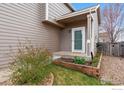 Charming front porch with small garden bed and a well-maintained yard at 6774 St Vrain Ranch Blvd, Firestone, CO 80504