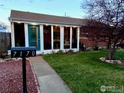 Charming home featuring a lush green lawn and a delightful sunroom at 7170 Zuni St, Denver, CO 80221