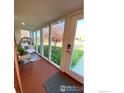 Cozy sunroom with large windows offering bright views and a relaxing sitting area at 7170 Zuni St, Denver, CO 80221