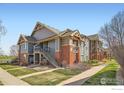 Inviting exterior of a multi-unit complex featuring well-maintained landscaping and classic architectural details at 804 Summer Hawk Dr # 3205, Longmont, CO 80504