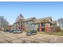 Well-maintained exterior of a multi-unit complex with ample parking at 804 Summer Hawk Dr # 3205, Longmont, CO 80504
