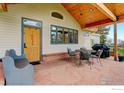 Inviting outdoor space with stone patio, wood ceiling, and seating area, perfect for relaxing or entertaining at 9445 Lykins Pl, Boulder, CO 80301