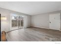Bright living room featuring modern floors and a sliding glass door to the outside at 12113 Melody Dr # 104, Denver, CO 80234