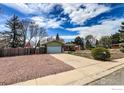 Quaint single Gathering home showcasing a brick exterior and a well-maintained front yard with mature landscaping at 12891 Columbine Dr, Longmont, CO 80504