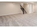A large open basement area with stairs leading to the upper level at 15 Chipeta Way, Lochbuie, CO 80603