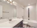 Bright bathroom featuring a modern vanity, large mirror, and tiled shower-tub combo at 15 Chipeta Way, Lochbuie, CO 80603