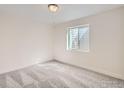 Bright bedroom with a large window and neutral carpet at 15 Chipeta Way, Lochbuie, CO 80603