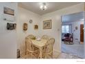 Cozy dining area with a quaint table and chairs, adjacent to the kitchen and living area at 1540 W 106Th Ave, Northglenn, CO 80234
