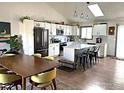 Open kitchen with an island, stainless steel appliances, and a dining area with modern furnishings at 1701 Sumner St, Longmont, CO 80501