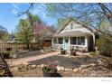 Charming home featuring a well-manicured front yard with a quaint walkway and seating area at 1830 9Th Ave, Longmont, CO 80501