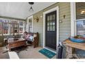Inviting front porch with a comfortable bench, decor, and a 'hello' welcome mat at the front door at 1830 9Th Ave, Longmont, CO 80501
