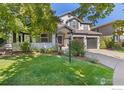 Lovely two-story home with brick accents, a well-maintained lawn, and a convenient three-car garage at 2001 Coralbells Ct, Longmont, CO 80503