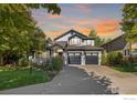Stunning two-story home with a manicured lawn, mature trees, and a three-car garage, perfect for Gathering living at 2001 Coralbells Ct, Longmont, CO 80503