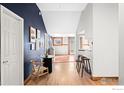 Inviting entryway with stylish decor, a round table, and hardwood flooring, leading to the kitchen at 2351 Federal Blvd # 102, Denver, CO 80211