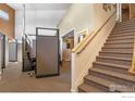 Hallway with staircase and office cubicles with neutral earth tone color palette at 2400 N Broadway # 5, Denver, CO 80205